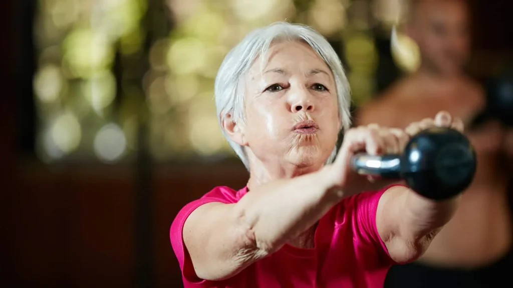 Toning Arms Without the Bulk: Is It Achievable? 1 Woman doing resistance band exercises for toned arms Bury St Edmunds